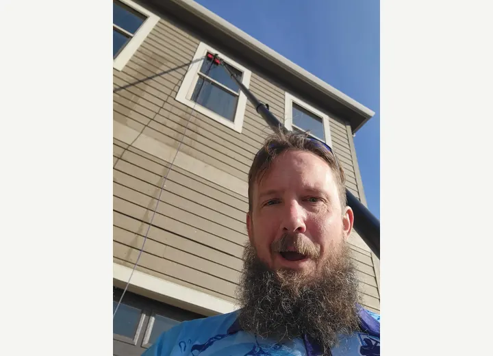 Deej working on a window cleaning project